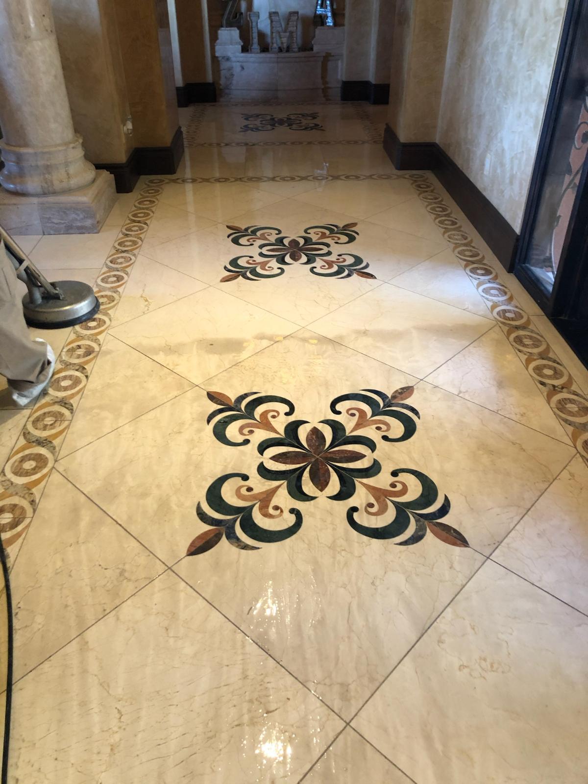 Sun Valley Carpet Care technician restoring a decorative marble tile entryway